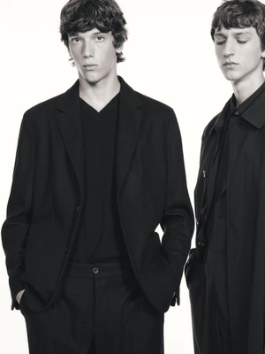 Two male models in black tailored suits posing against a plain white background for Massimo Dutti