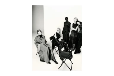 Group of models in dark clothing posed together in a white seamless studio environment for Massimo Dutti