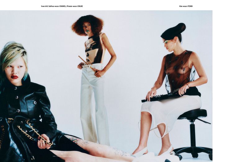 Three fashion models strike poses in a studio setting, showcasing a variety of clothing and accessories in soft, diffused lighting.