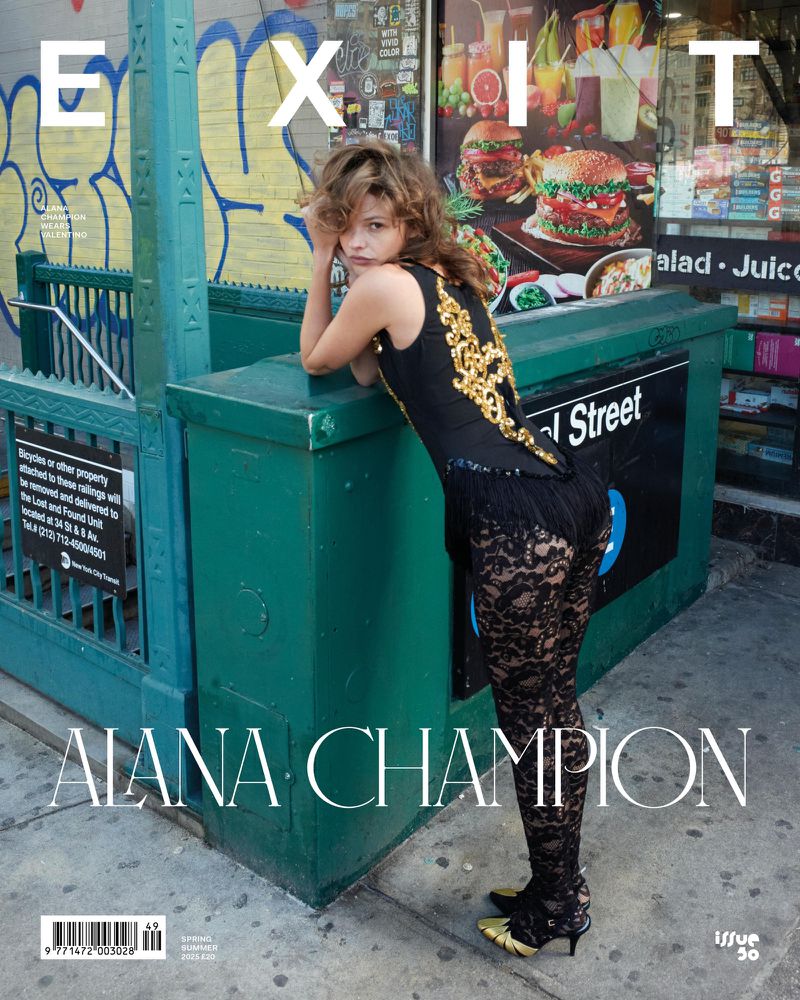 Magazine cover featuring a woman in a black and gold outfit leaning against a green subway entrance with graffiti in an urban setting.