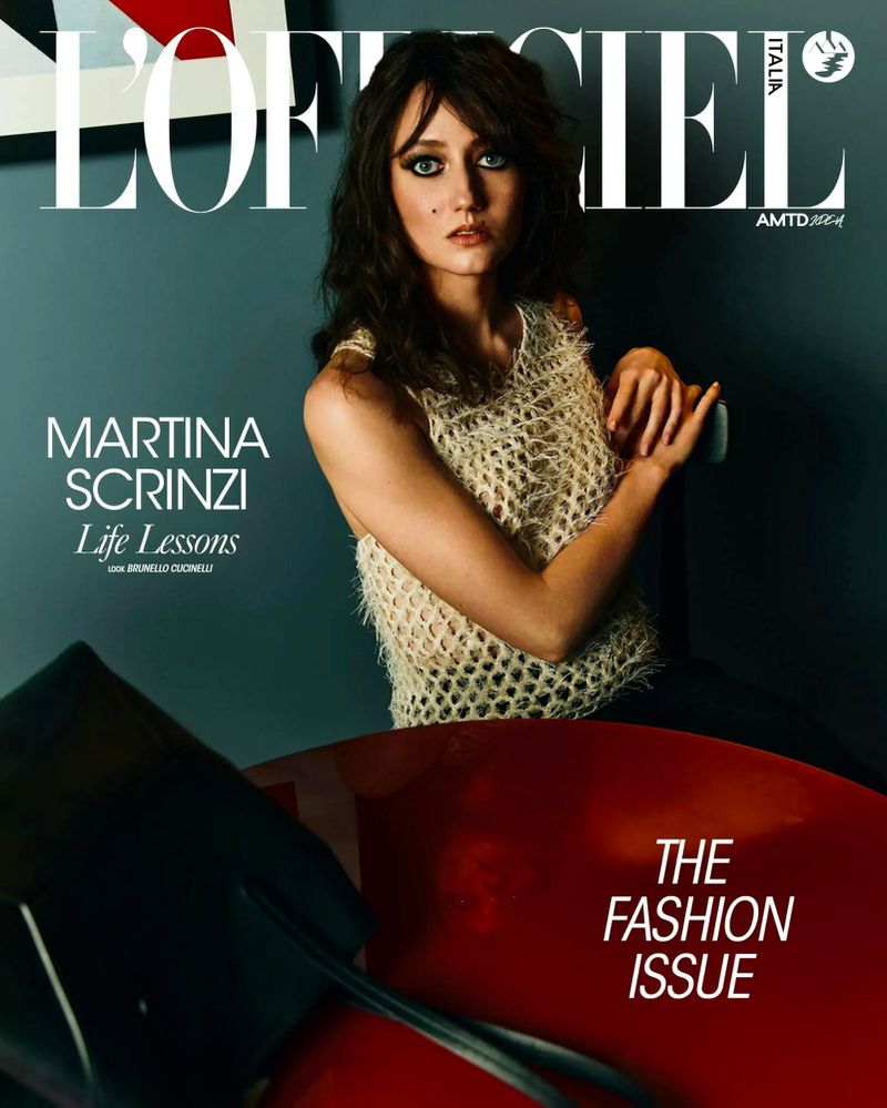 Magazine cover featuring Martina Scrinzi in a net top, posing against a dark gray wall with a red chair. The text reads L'Officiel Italia.