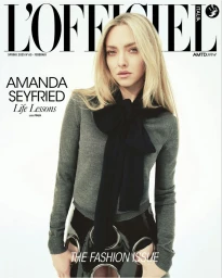 Amanda Seyfried on L'Officiel Italia cover wearing grey long-sleeve knit top and black glossy skirt against plain background