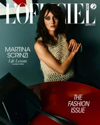 Woman in a textured cream top posing against a dark teal wall for L'Officiel Italia magazine cover