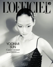 Model Yoonmi Sun wearing a black beaded gown with a decorative hairpin for L'Officiel Italia magazine cover