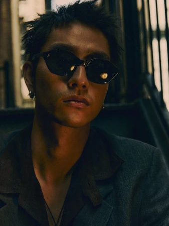 Portrait of a man wearing dark sunglasses and a dark jacket outdoors in New York