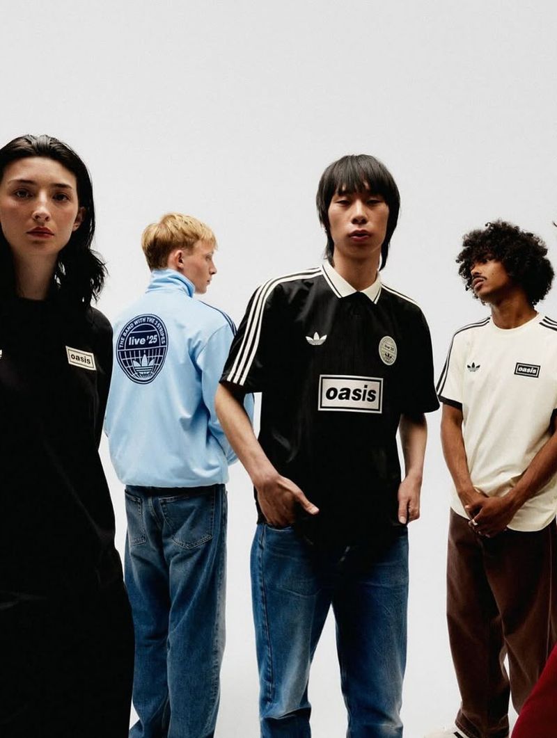 Group of multi-ethnic people wear Adidas x Oasis branded tracksuits and t-shirts in a studio with a bright white background.