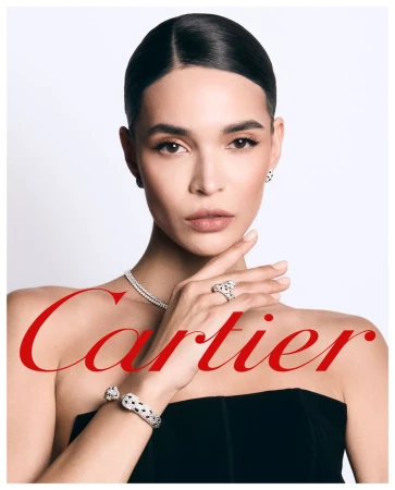 Woman wearing diamond panther jewelry and a black top against a white background with Cartier logo overlay