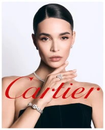 Woman wearing diamond panther jewelry and a black top against a white background with Cartier logo overlay
