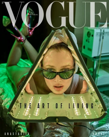Vogue Portugal cover featuring a model in sunglasses with an LED face mask, lying down, with the magazine's title and 'The Art of Living'.