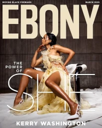 Kerry Washington seated in a sculptural chair wearing a tiered pale yellow dress for Ebony Magazine March 2025 cover.