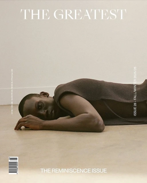 Magazine cover features a Black male model lying on a neutral floor wearing a brown sleeveless top, with magazine text and graphics.