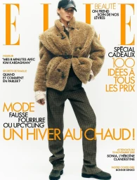 Model Bonnie Panasenko wearing an oversized shearling jacket, plaid trousers, and a baseball cap on the cover of Elle France.