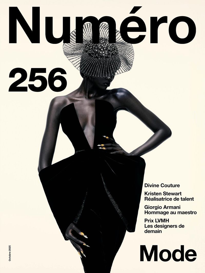 A fashion magazine cover features a model in a black dress and headpiece against a cream background, with bold magazine text.