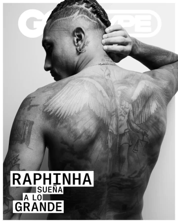 Black and white studio shot of a man's back, showing off a large angel tattoo, with the GQ Type magazine masthead visible in the shot.