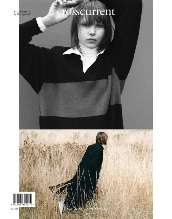 Magazine cover featuring a model in a striped rugby shirt, set against a backdrop of tall wheatgrass and a woman in a long dark coat.