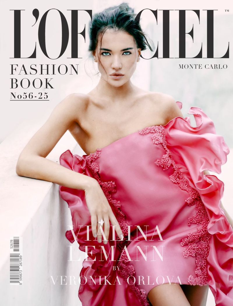 Magazine cover featuring a young adult woman with dark hair wearing a pink dress with lace details, posing against a neutral background.