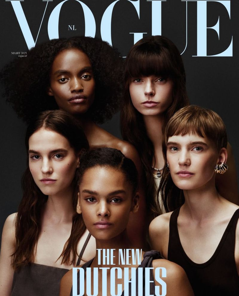 Vogue cover featuring a group of five diverse young women with various hairstyles, gazing directly at the camera against a dark backdrop.