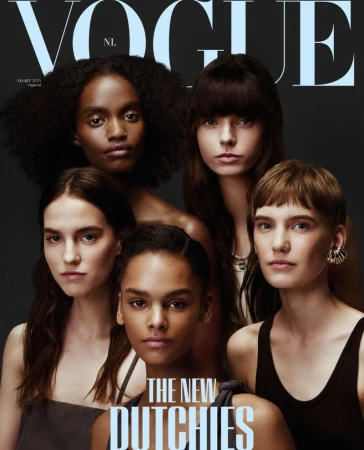 Vogue cover featuring a group of five diverse young women with various hairstyles, gazing directly at the camera against a dark backdrop.