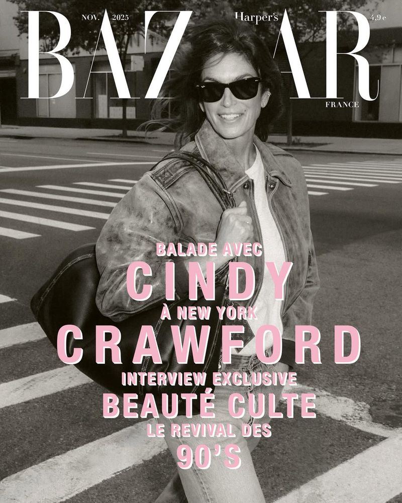 Cindy Crawford on Bazaar cover: Cindy Crawford walks on a city street wearing a jacket, T-shirt, and sunglasses. Harper's Bazaar logo is visible.