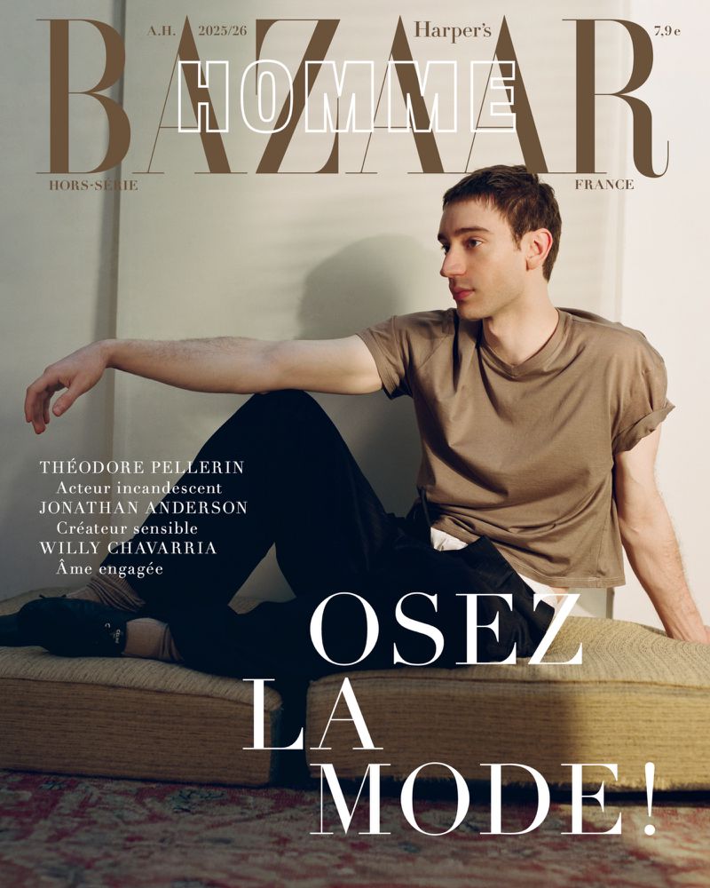 Actor Théodore Pellerin in a taupe t-shirt and dark trousers reclining on a low daybed on a Harper's Bazaar France Homme cover.