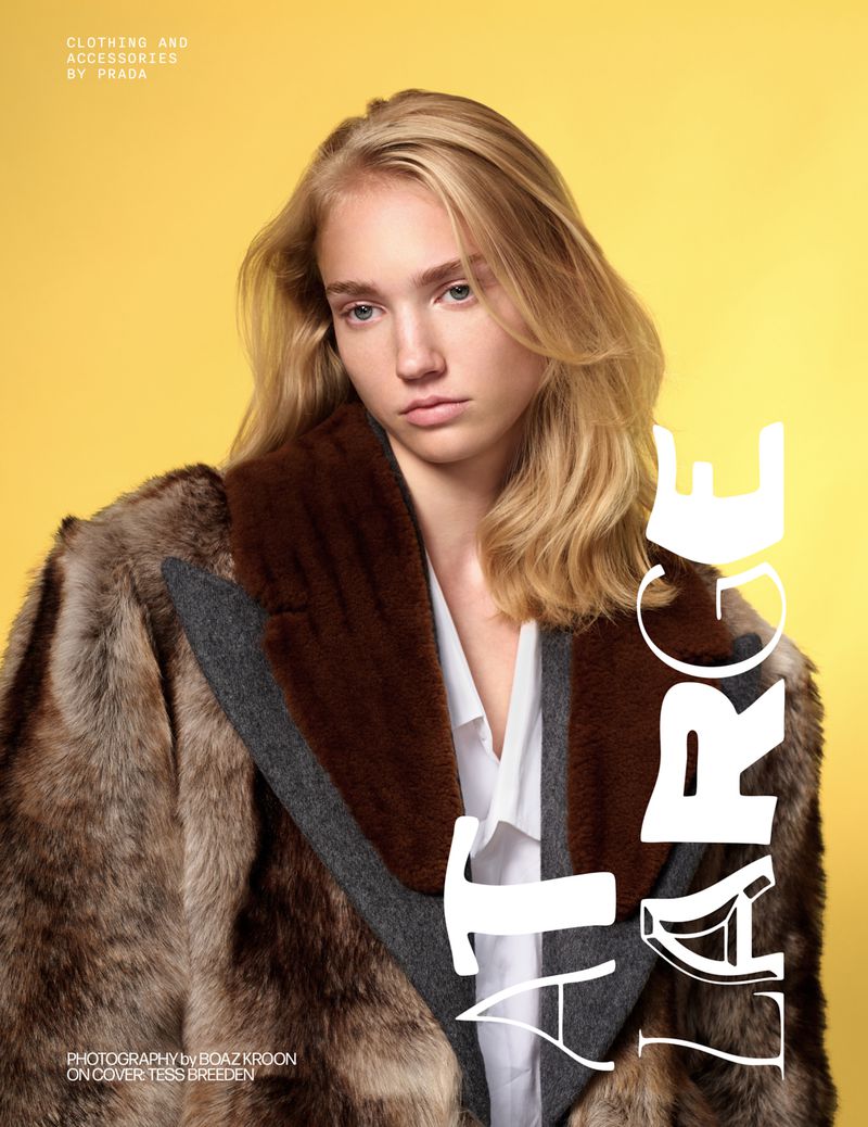 Fashion portrait of a young woman in a fur coat against a yellow backdrop, featuring blonde hair, neutral makeup, and studio lighting.