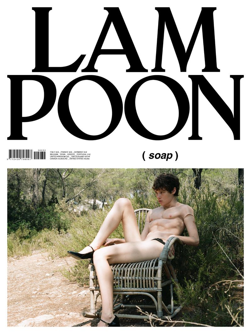 Magazine cover featuring a young adult male with a slender build, seated in a chair outdoors in a natural environment.