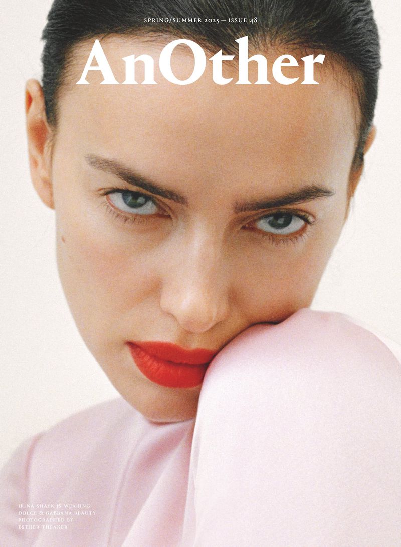 Close-up fashion magazine cover featuring a female model with red lipstick, a serious facial expression, and styled hair.