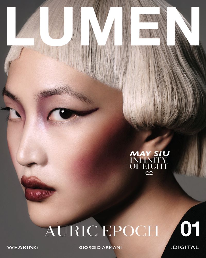 Close-up portrait of a woman with creative makeup and a short blonde bob haircut, featured on the cover of Lumen magazine.