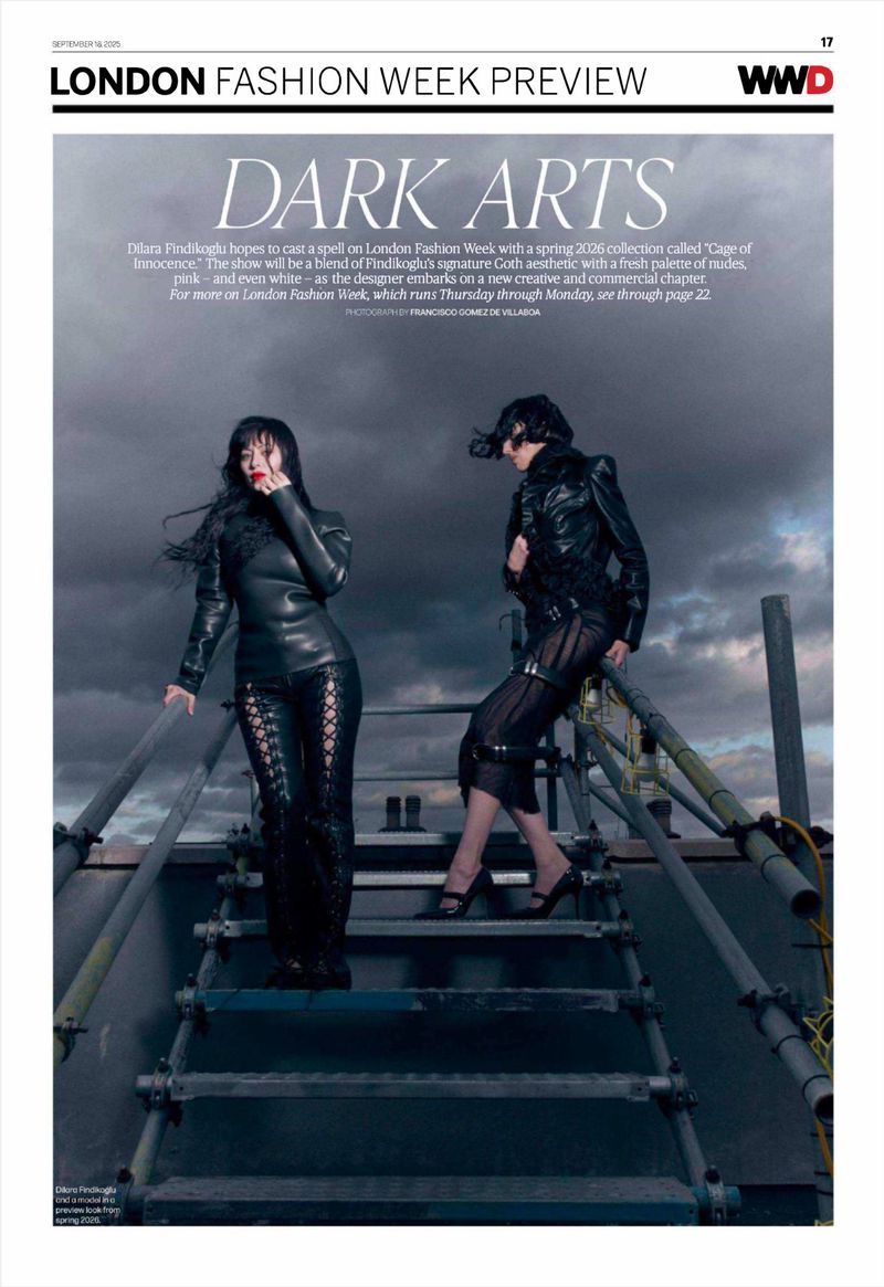 Two fashion models pose on a metal staircase in black clothing for a London Fashion Week preview, showcasing dark arts and gothic aesthetics.