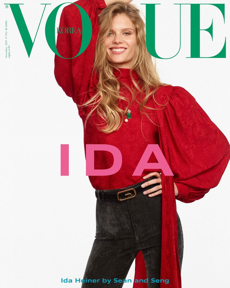 Vogue Korea cover featuring Ida Heiner in a red blouse and black jeans, smiling with blonde hair, against a white background.
