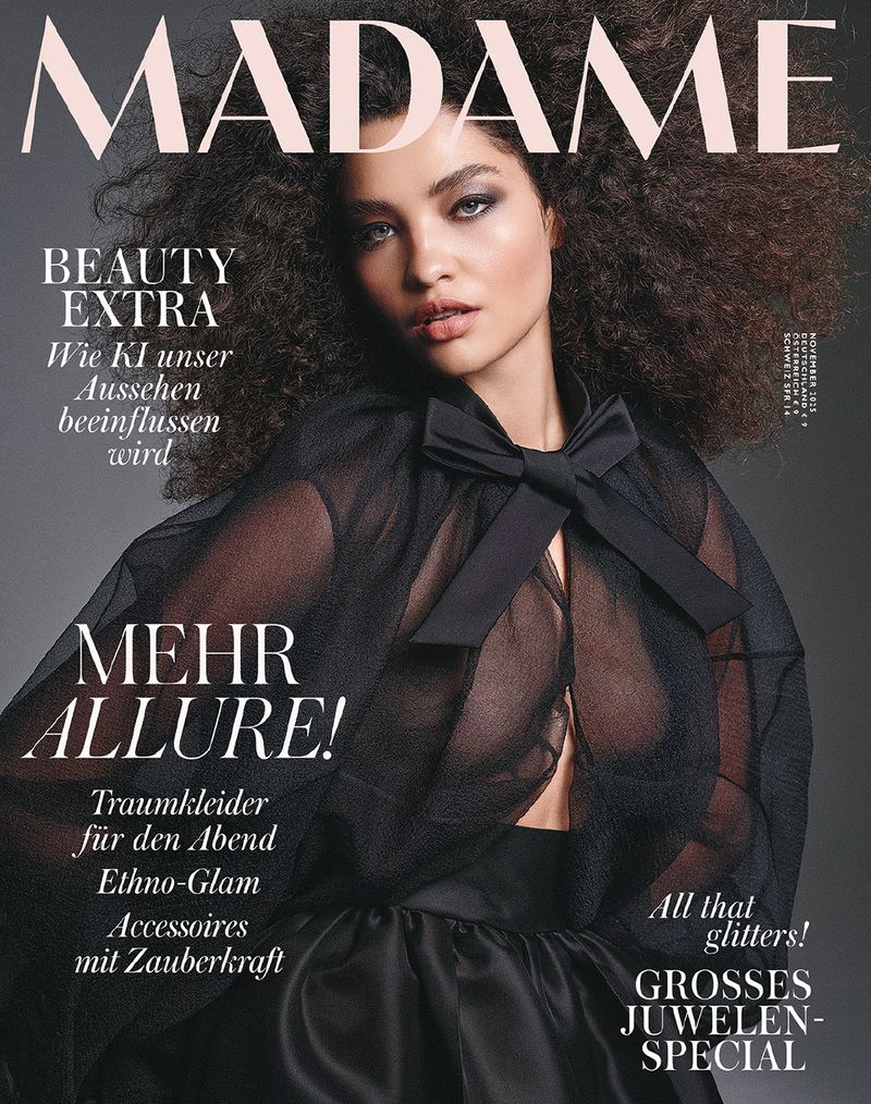 Magazine cover featuring a woman with curly hair wearing a black top, text reads 'MADAME' and other magazine headlines.