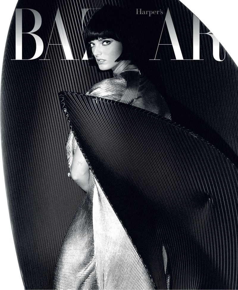Harper's Bazaar magazine cover featuring a model in a silver dress with black linear sculptural panels framing the subject.