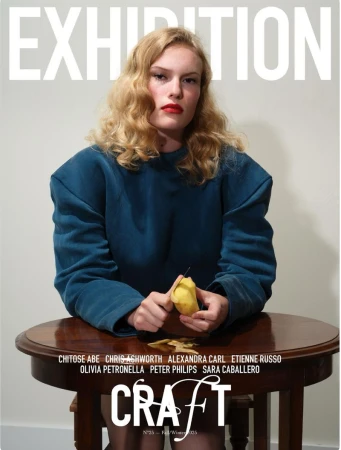 Magazine cover features a blond woman in a blue sweater peeling a pear at a table with text overlay; 'EXHIBITION' and 'CRAFT'.