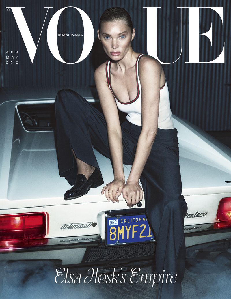 Vogue Scandinavia magazine cover featuring Elsa Hosk posing on a white vintage car wearing a tank top and loose pants.