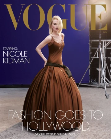 Vogue magazine cover featuring Nicole Kidman in a brown dress with a black bow, set against a blue backdrop with studio lighting.