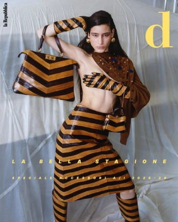 Magazine cover featuring a woman in a striped outfit with a handbag and gloves, alongside fashion editorial text and a logo.