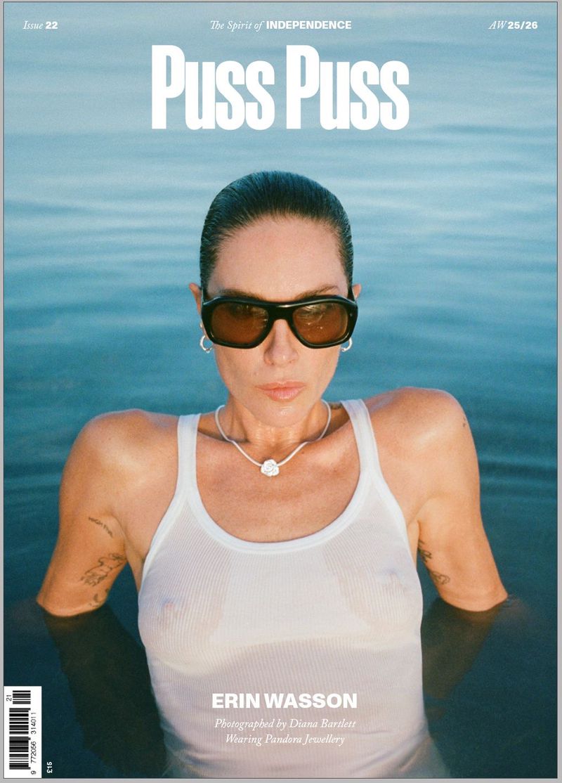 Magazine cover featuring a woman in a white tank top in water, wearing sunglasses and a necklace, with 'Puss Puss' in bold text.