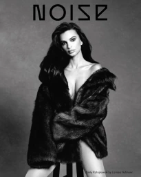 Emily Ratajkowski wearing a dark textured coat against a grey seamless background for Beyond Noise