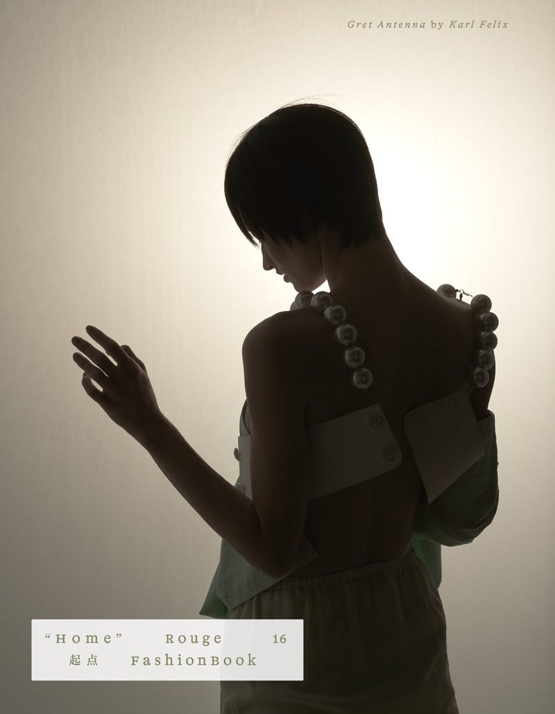 Fashion photo of a young woman in muted tones, featuring a beaded strap dress, soft lighting, and studio backdrop.