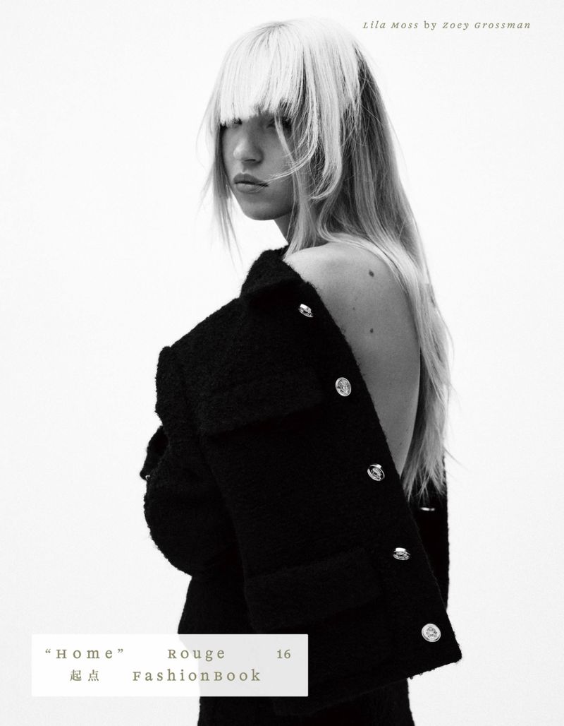 Monochrome fashion shot of a woman in a black textured jacket with silver buttons against a bright background, showcasing editorial style.