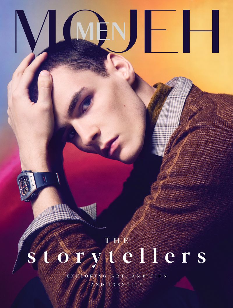 Magazine cover featuring a young man with brown hair wearing a patterned brown jacket, posed against a colorful gradient background.
