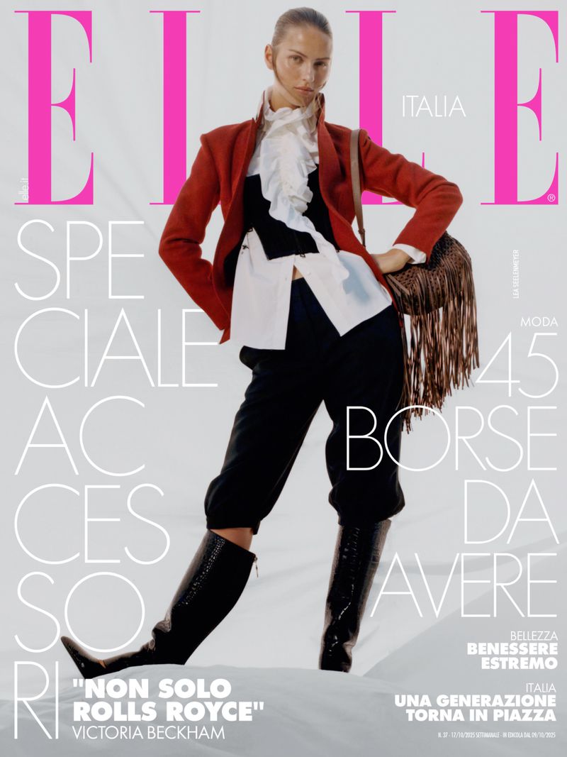 Elle Italia magazine cover featuring a woman in a red blazer, black pants, and knee-high boots, accessorized with a fringed bag.
