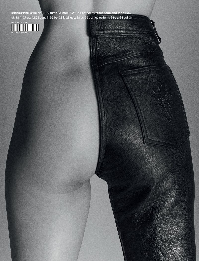 Black and white photograph of a human torso and legs with one side bare skin and the other side wearing leather pants.