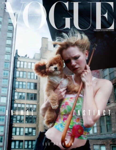 Vogue Portugal cover featuring a woman holding a small dog outdoors in front of city buildings, posing with a black umbrella.