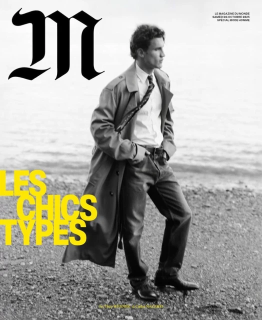 Magazine cover featuring a male model in a trench coat on a beach, with the magazine's logo and yellow text overlaying the image.
