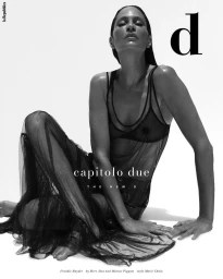 Black and white portrait of model Frankie Rayder in a sheer dark dress against a white background for D Repubblica magazine cover.