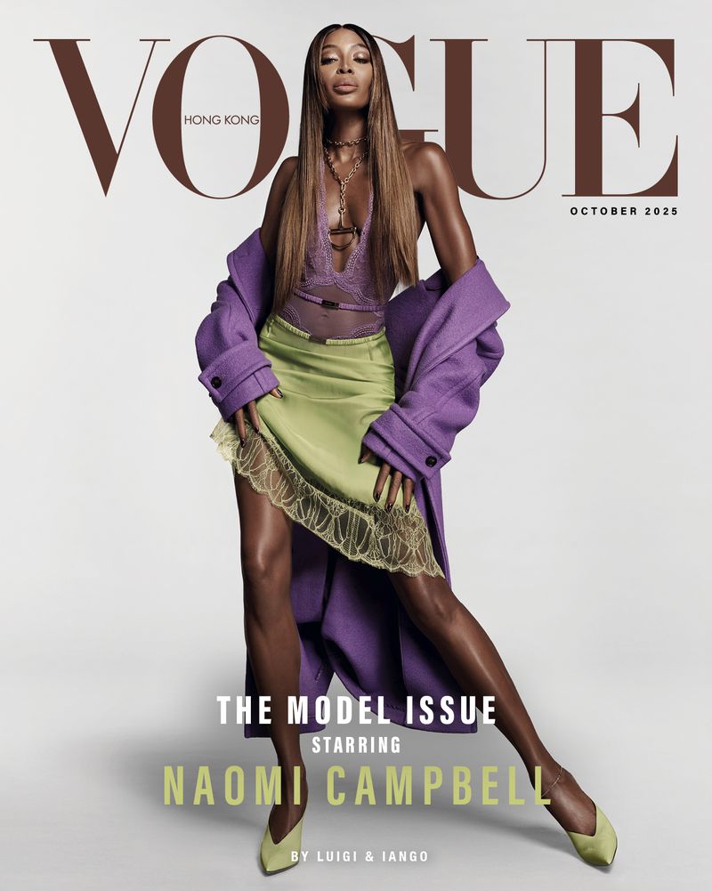 Naomi Campbell graces Vogue Hong Kong's October 2025 cover in a purple coat, lime green skirt, and matching shoes, posing against a white backdrop.