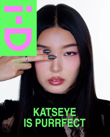 East Asian woman covering one eye with manicured fingers in a close-up portrait for an i-D magazine cover.
