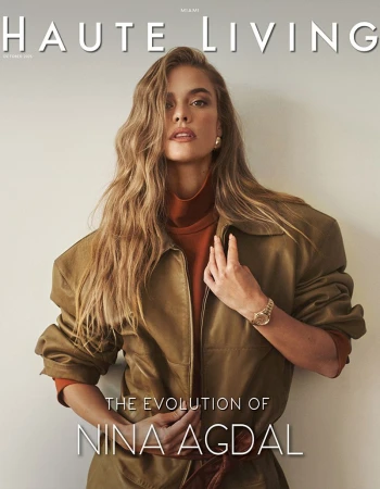 Magazine cover featuring a woman with long blonde hair wearing a brown jacket and turtleneck, posed against a neutral background.