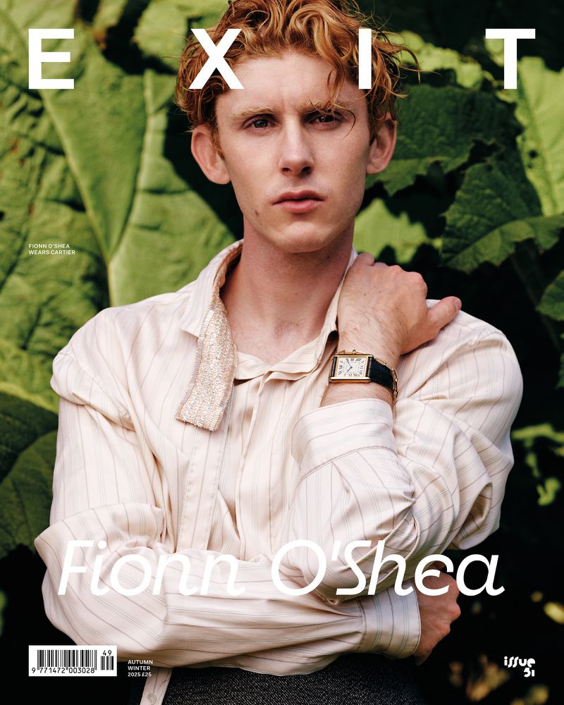Exit magazine cover featuring a portrait of Fionn O'Shea, with green foliage background, wearing a striped collared shirt and a watch.